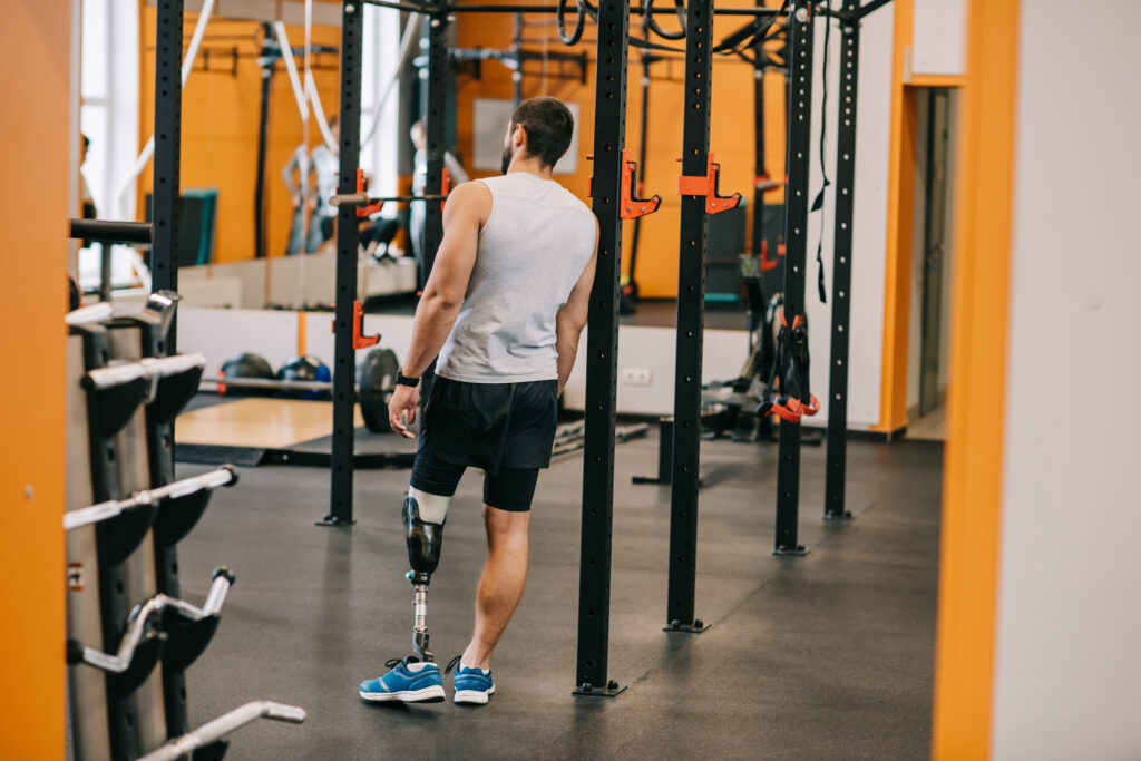 Athlete with prosthetics standing in a gym preparing for an active training session