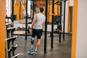 Athlete with prosthetics standing in a gym preparing for an active training session