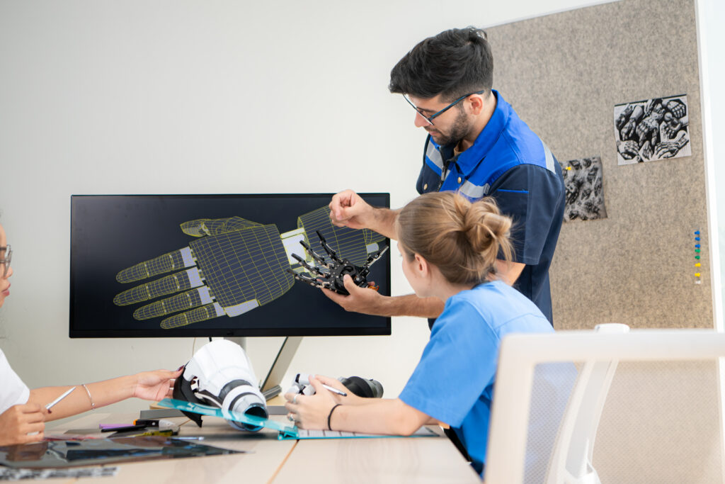 Medical team collaborating on custom prosthetics design using digital modeling and engineering tools